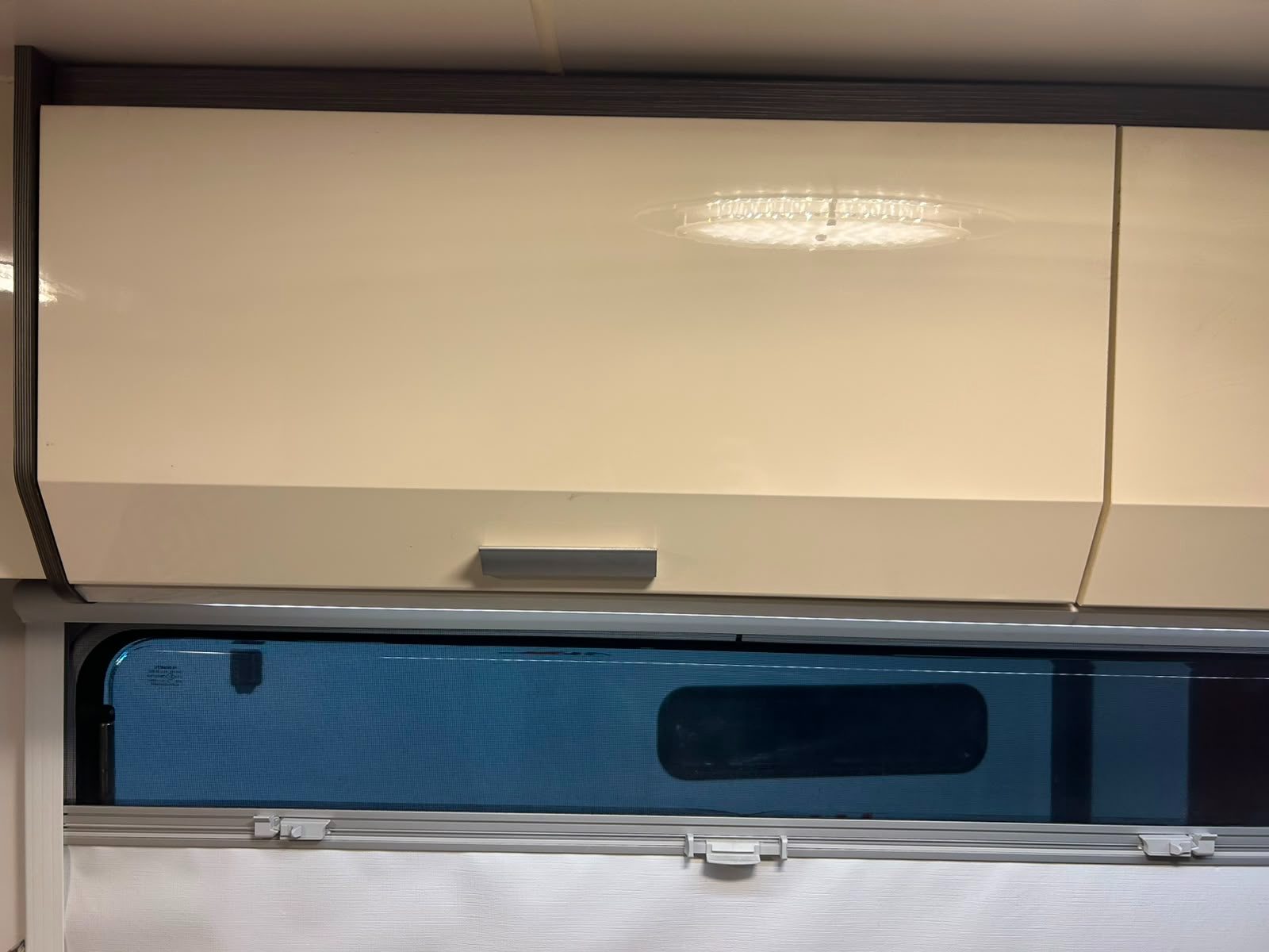Interior caravan overhead cabinet housing the Gusto Dust Reduction System with vent alignment completed by G&S Caravan Services